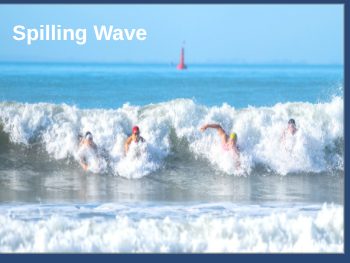 Gentle spilling wave rolling softly onto a sloping beach
